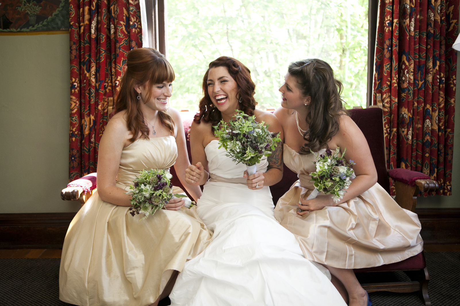 bride and bridesmaids laughing together before the ceremony in portland