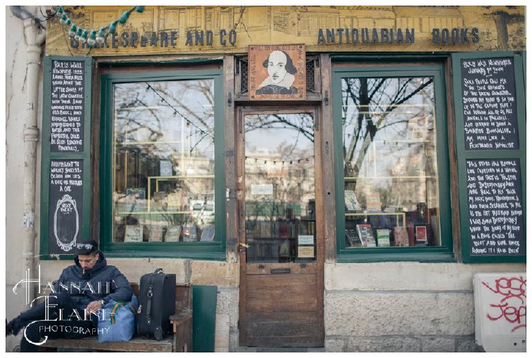 a man reads in front of shakespeare and company bookstore in paris