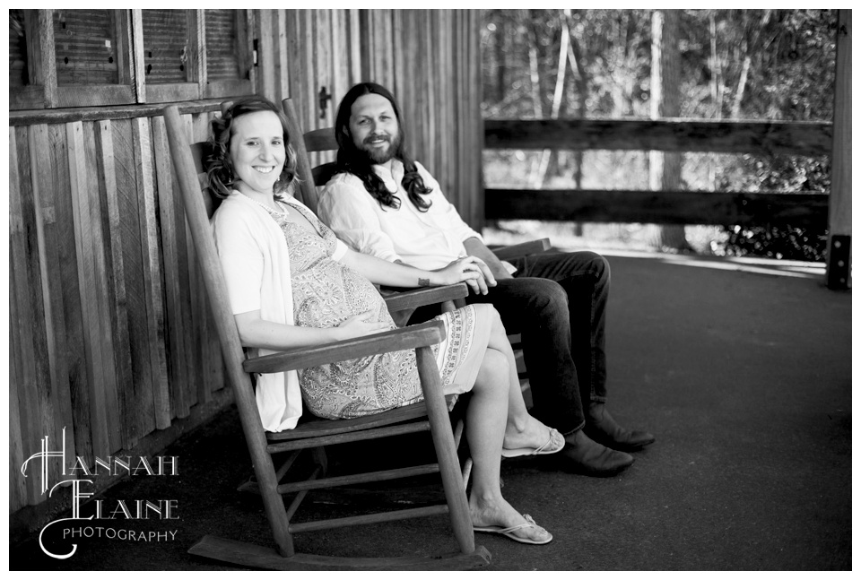 pregnant couple rocks on the porch at arrington