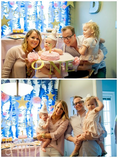 family takes a photo before cake smash at first birthday party