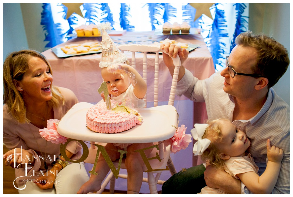 pink cake smash action shot at first birthday party