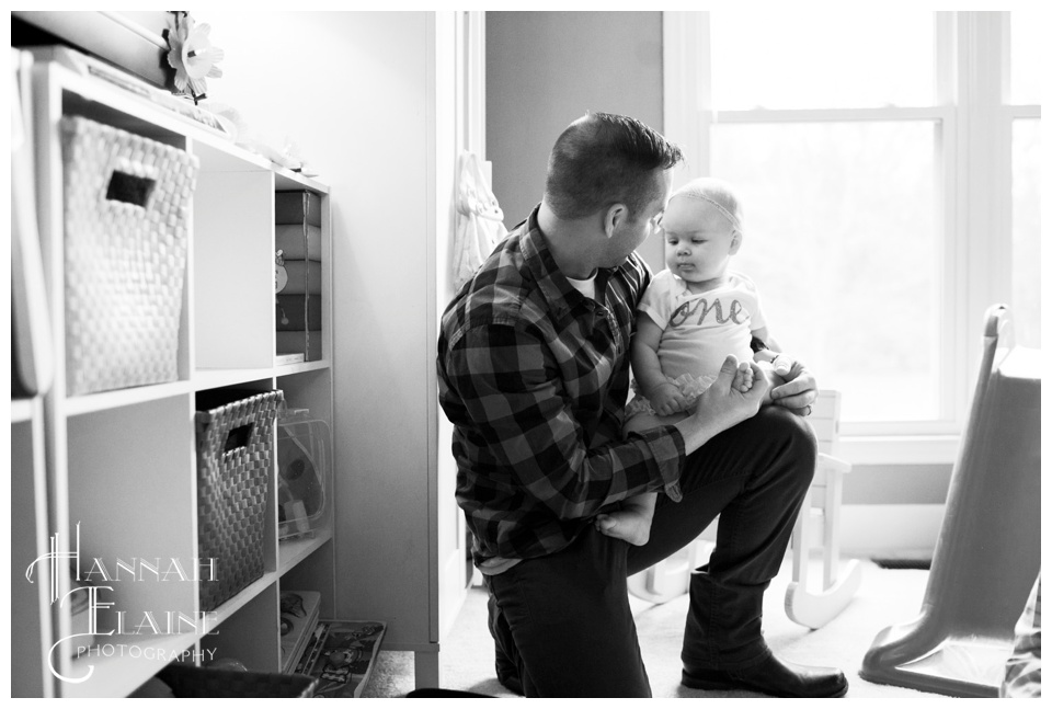 uncle holds his niece on her first birthday party