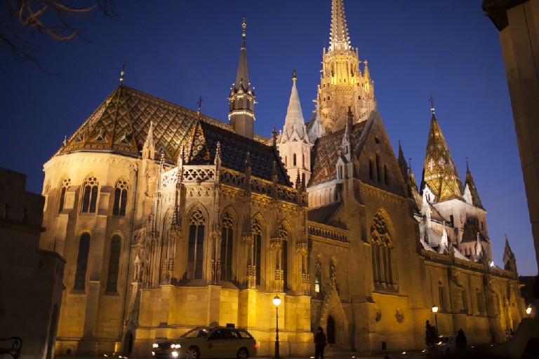 massive matthias cathedral lit up at dusk on buda hill