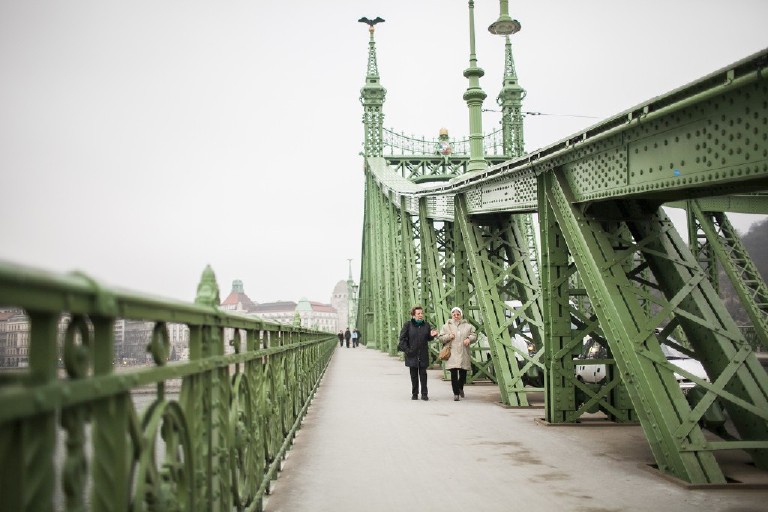two women walk on the liberty bridge