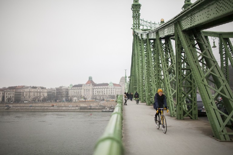 liberty bridge with a yellow bicyclest