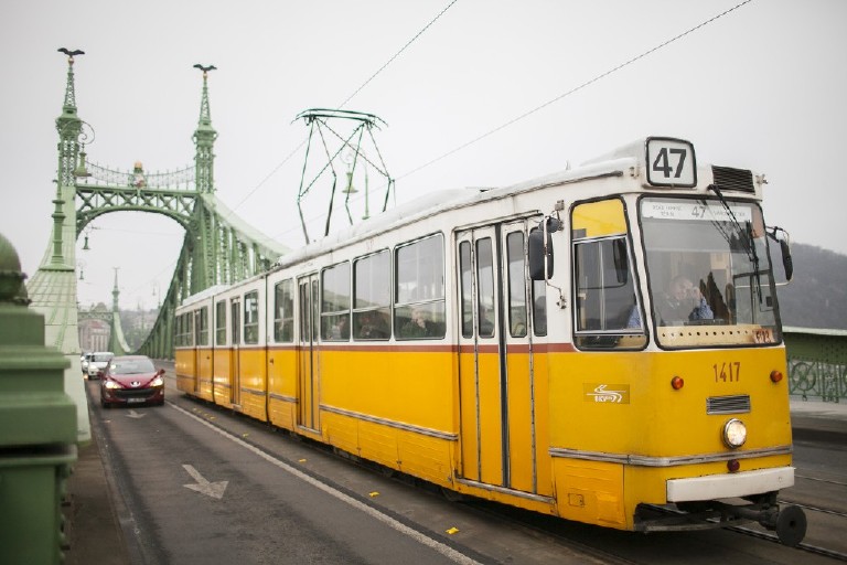 yellow tram coming across liberty bridge 