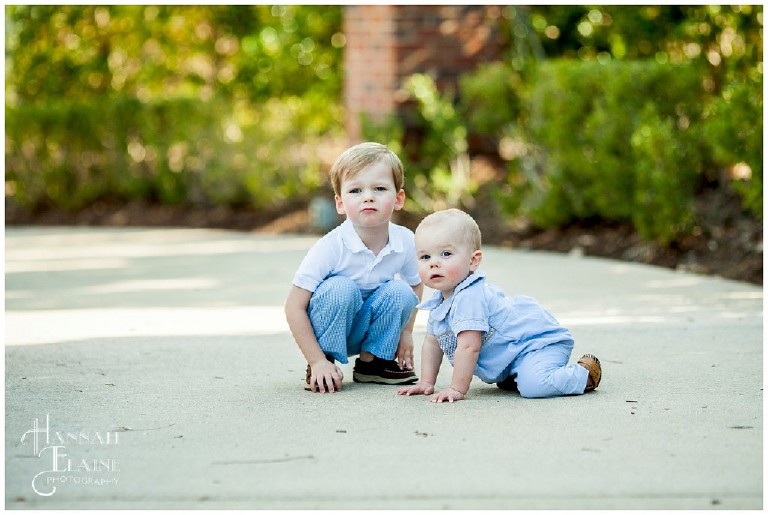 brothers play on the shaded sidewalk