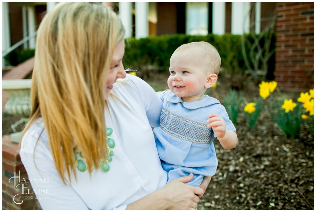 henry smiles for his mom in the daffodil field