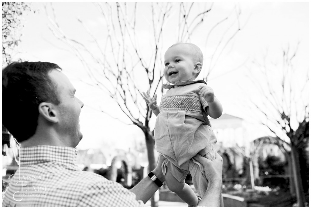 a dad hoists his son in the air to bring a smile