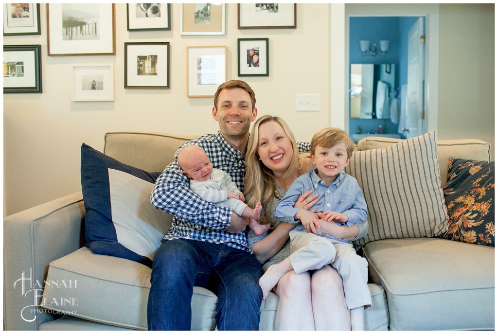 family takes photos on comfy couch in their east nashville home