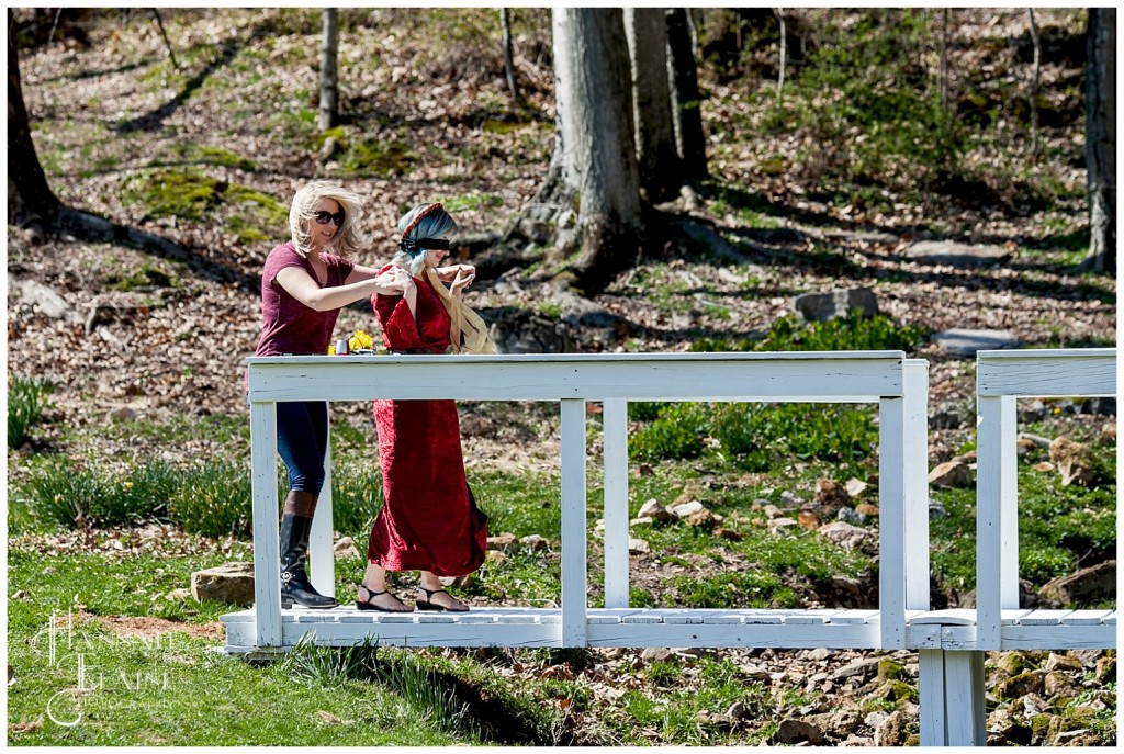 blindfolded girl steps onto white bridge