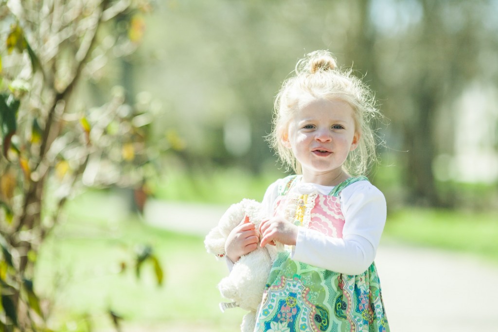 sweet girl carrying her bunny in the park