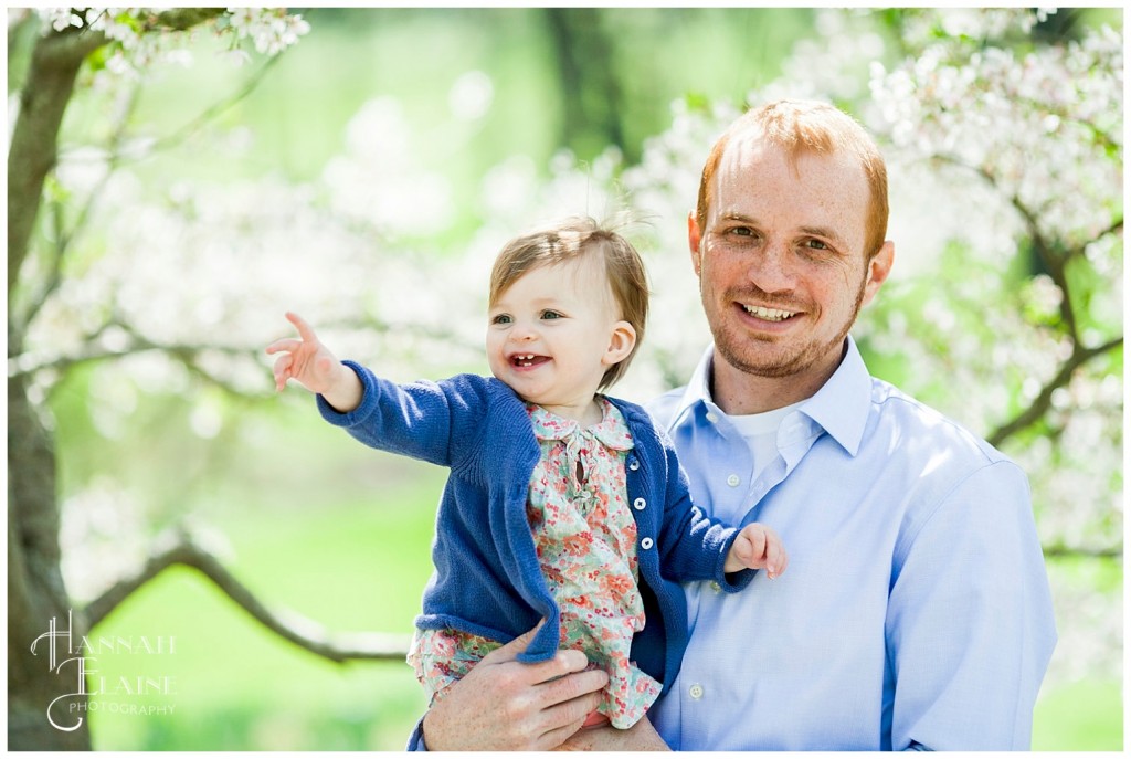 posing for easter photos under the blooming tree