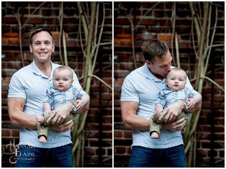 father and son cuddle against a rustic brick background