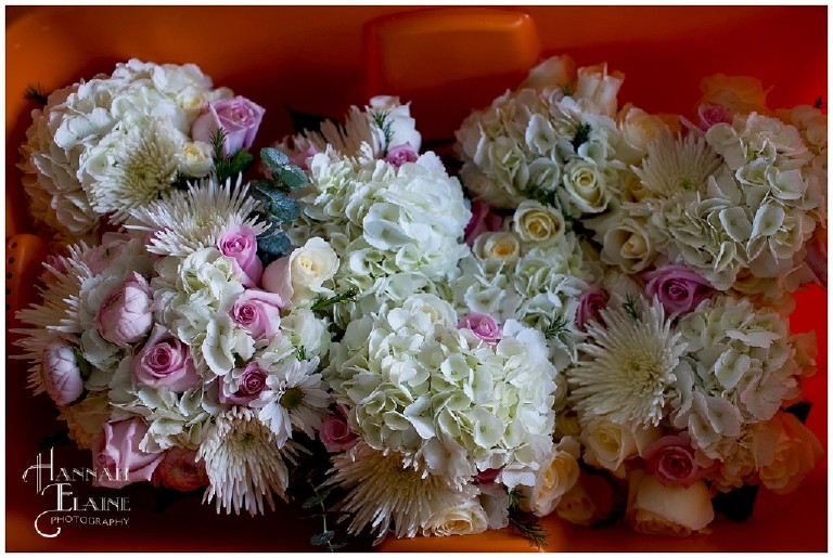 bridal party flowers in an orange bucket