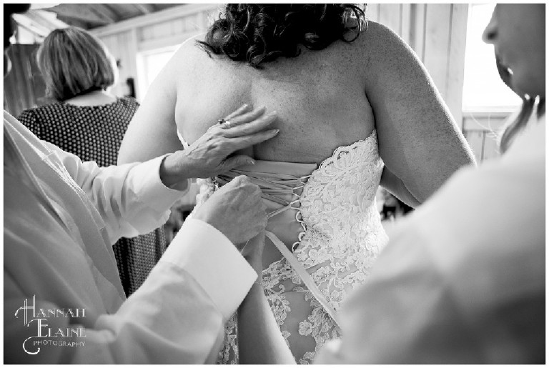 mother of the bride and bridesmaid lace up the back of a bridal gown