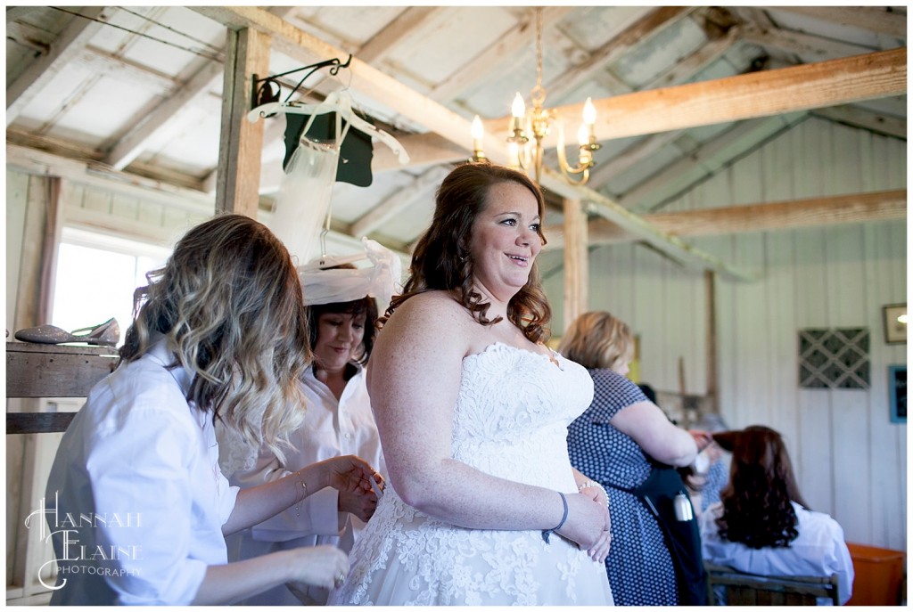 a bride gets into her gown