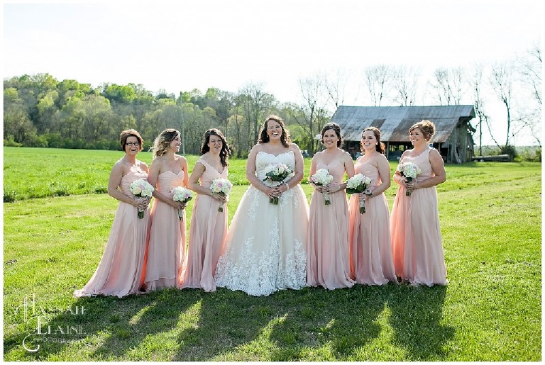 bridesmaids in blush in a country field