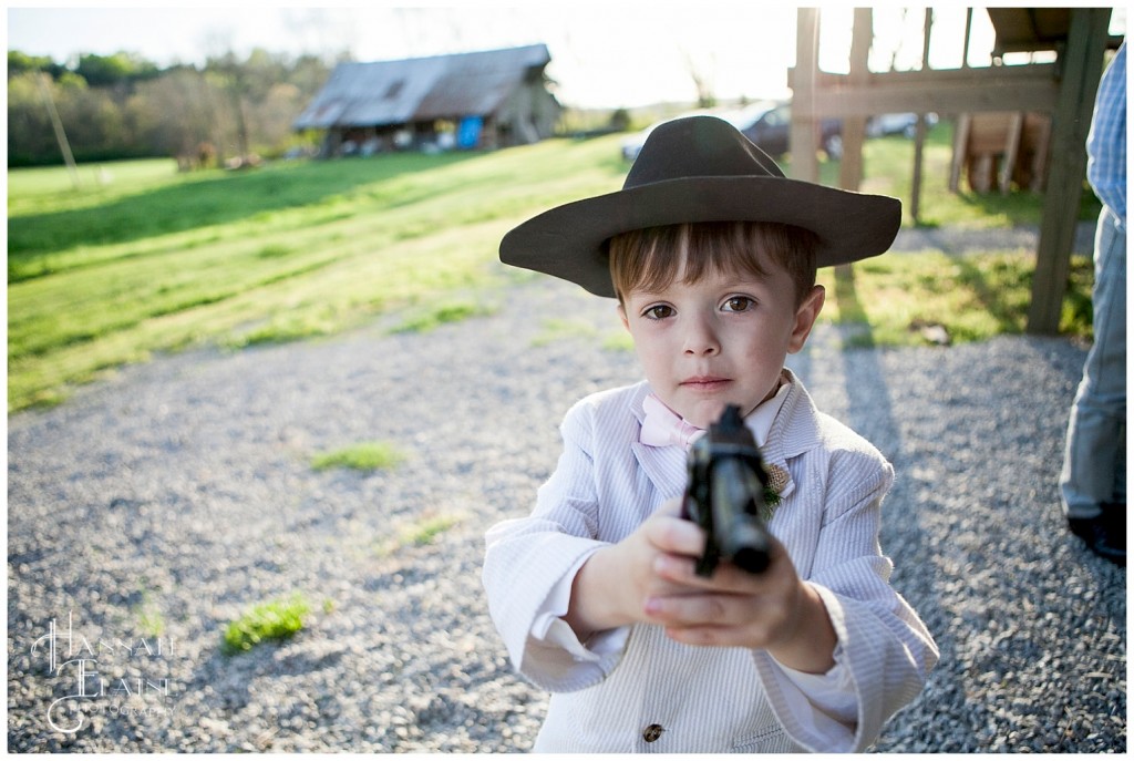 little boy steals cowboy props from the photobooth