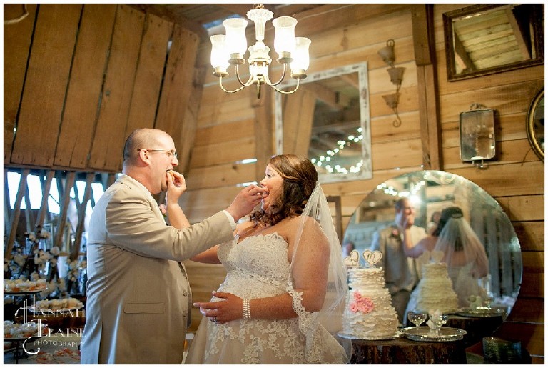 a newlywed couple smashes the cake in each other's face