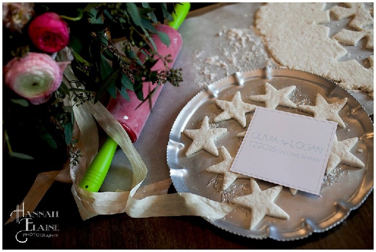 a save the date card next to star shaped biscuits and vintage rolling pin