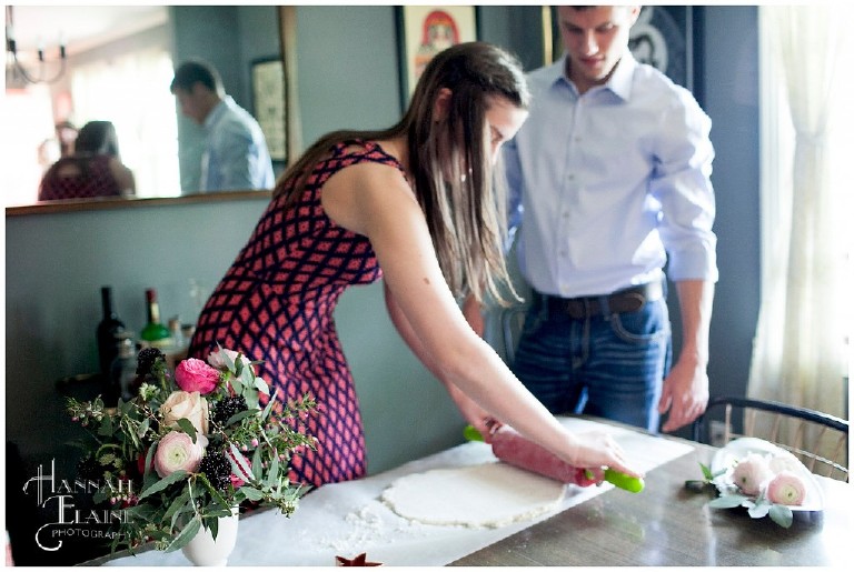 newly engaged couple makes star shaped biscuits with vintage rolling pin