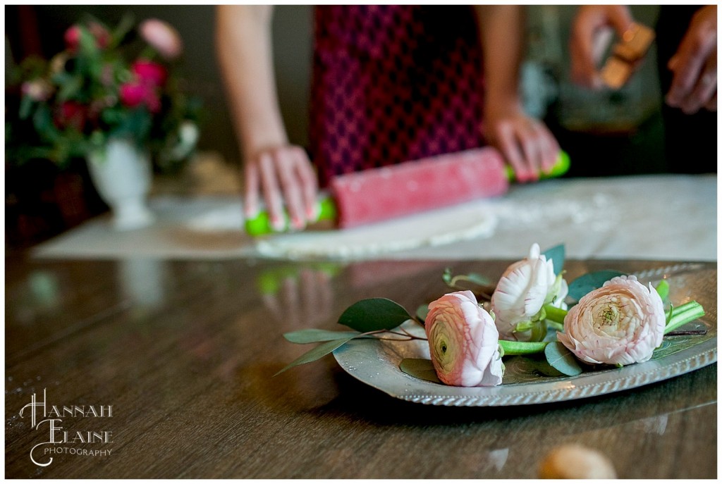 ranunculous styled on vintage silver platter next to rolling pin and biscuits