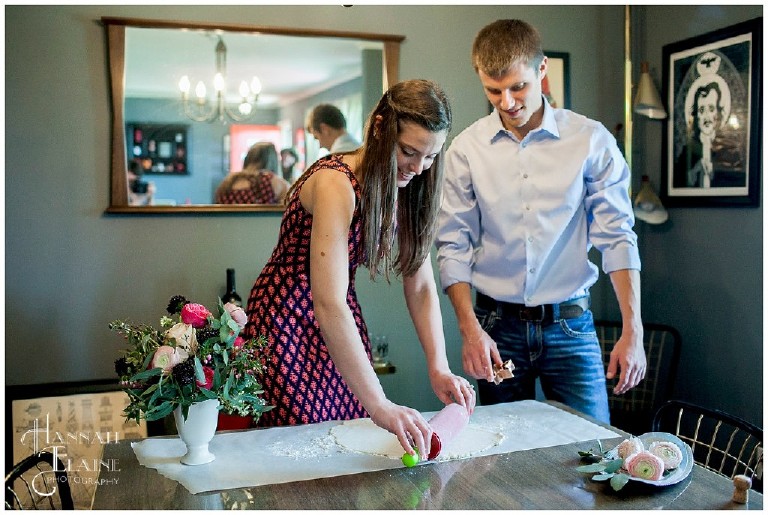 engaged couple makes biscuits in formal wear