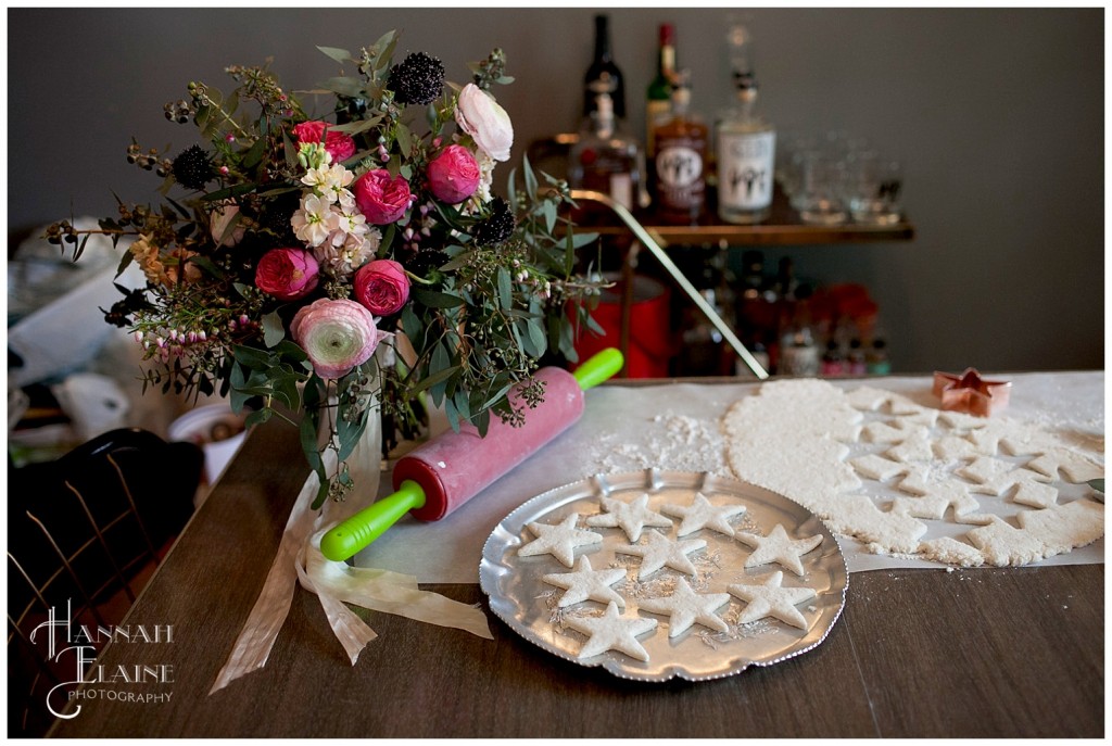 star shaped biscuit dough and pink and red ranunculus and liquor cart