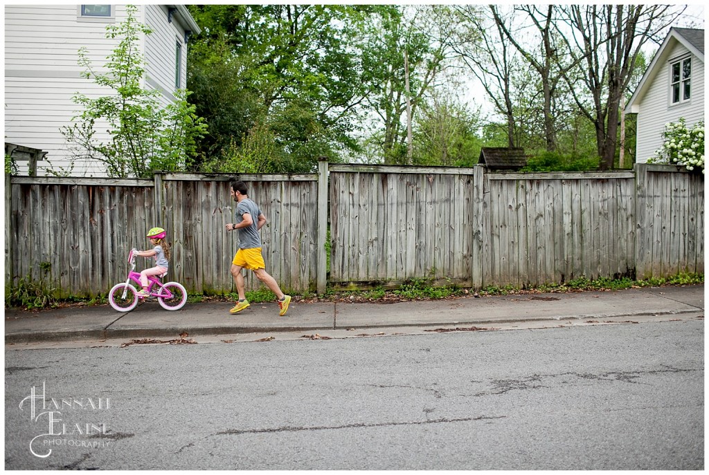 dad runs and daughter bikes on russell street on the east side