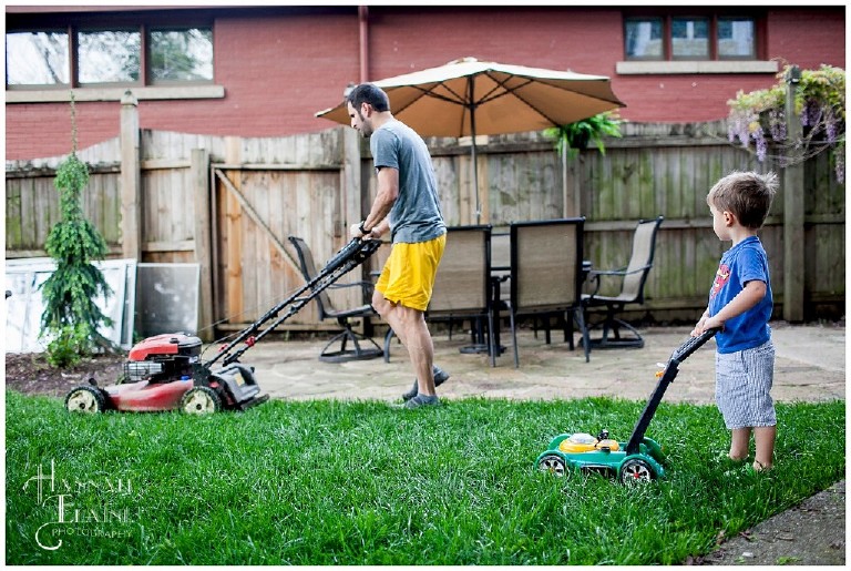 son helps dad mow the backyard