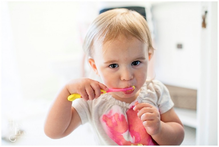 baby girl brushes her teeth