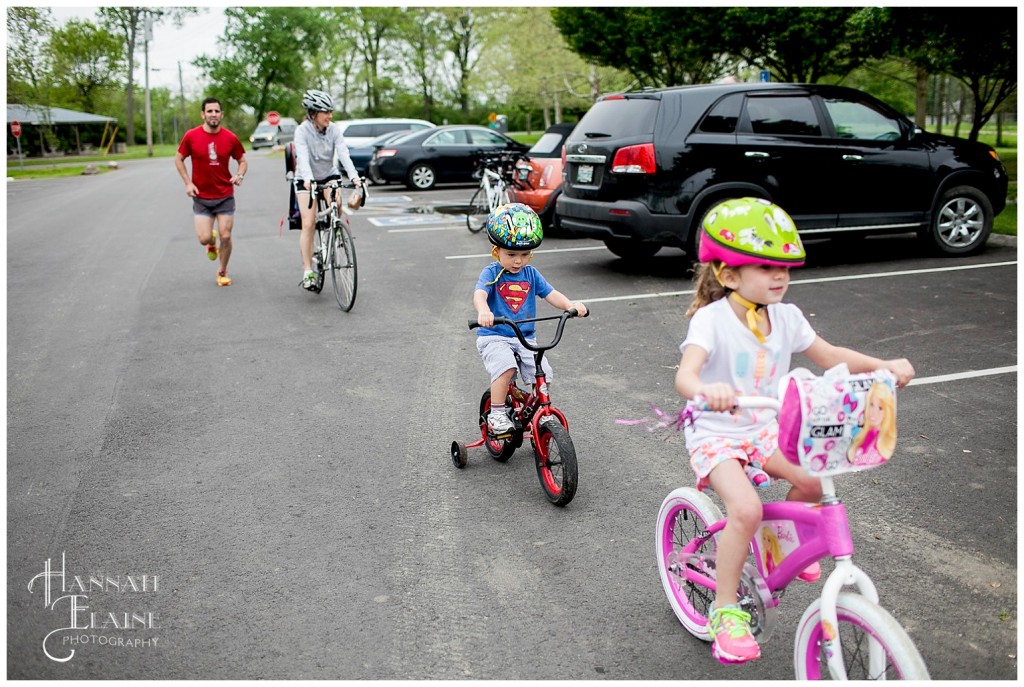 family goes for ride on bikes in shelby park