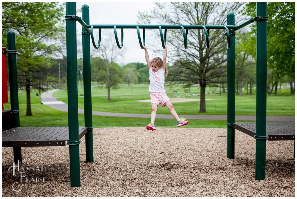 playing the monkey bars at shelby park playground