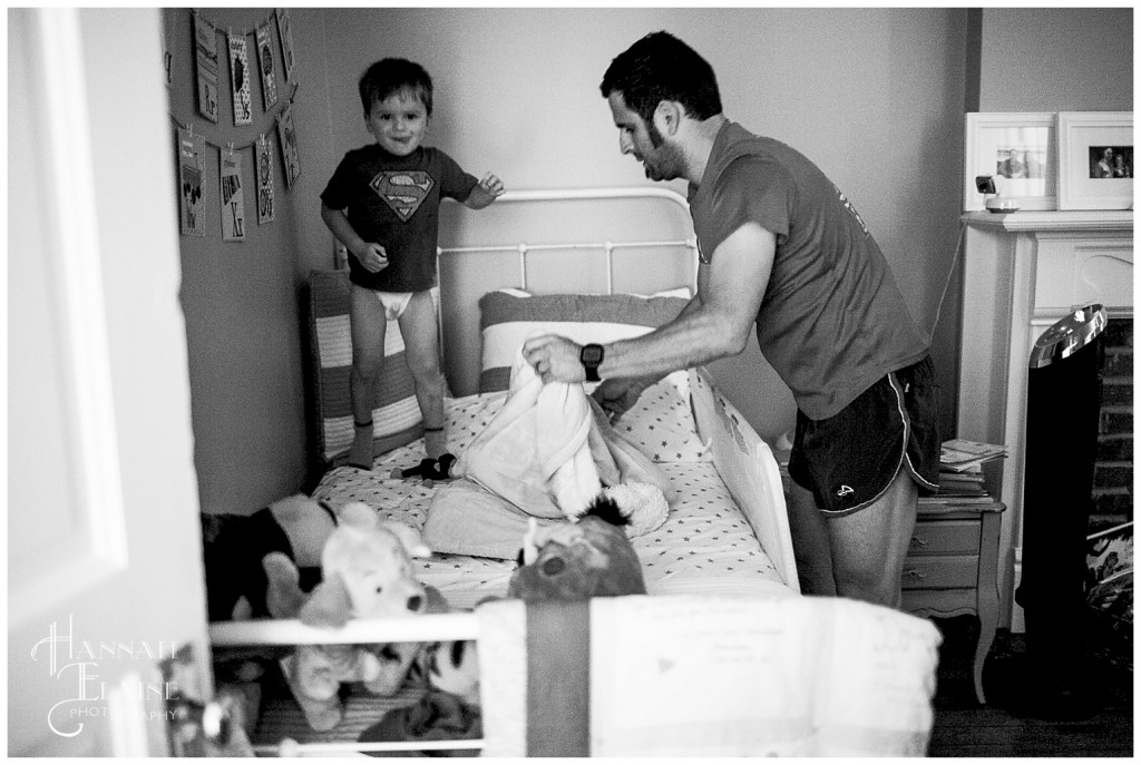 boy jumps on the bed as dad tries to fix the covers for nap time