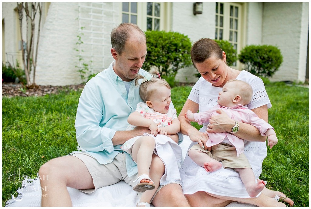 mom and dad tickle their son and daughter