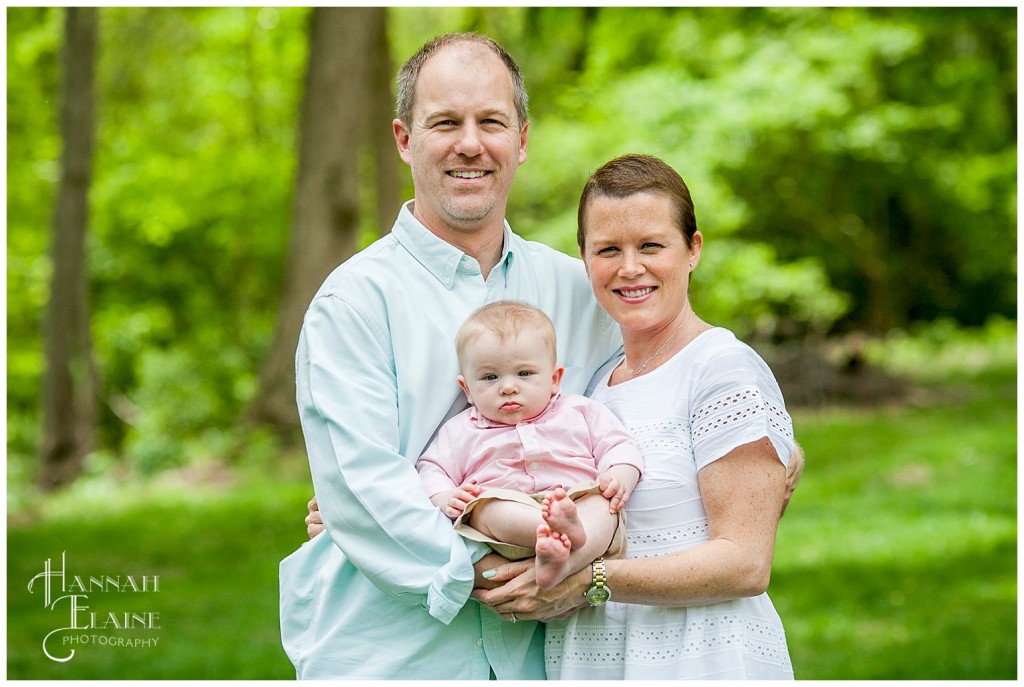 mom and dad hold their son for a photo