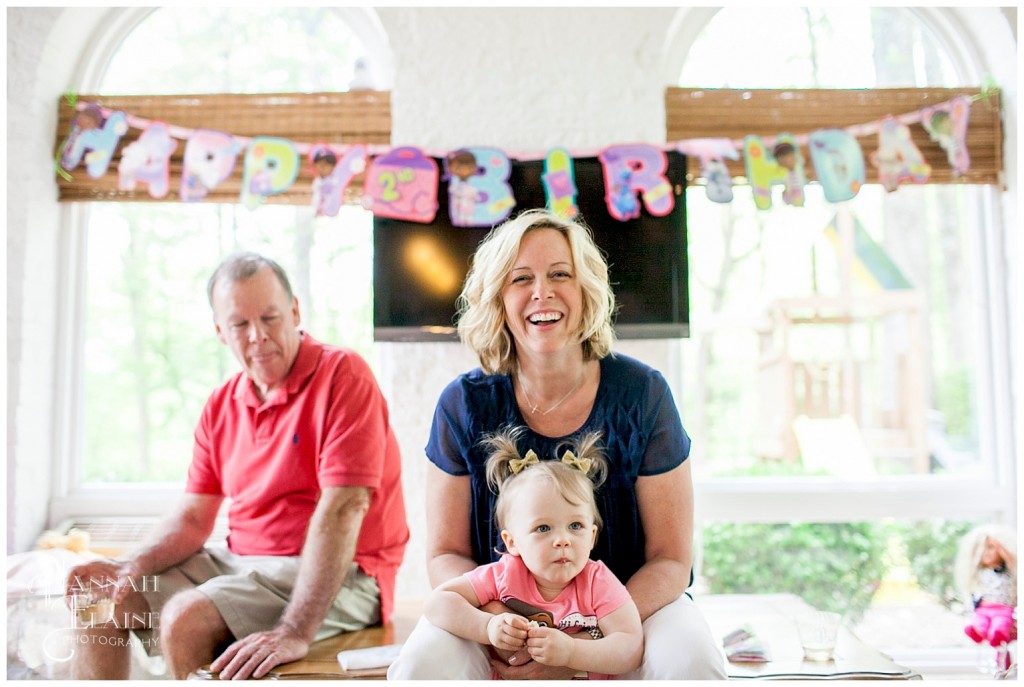 candid smiles in front of the birthday banner