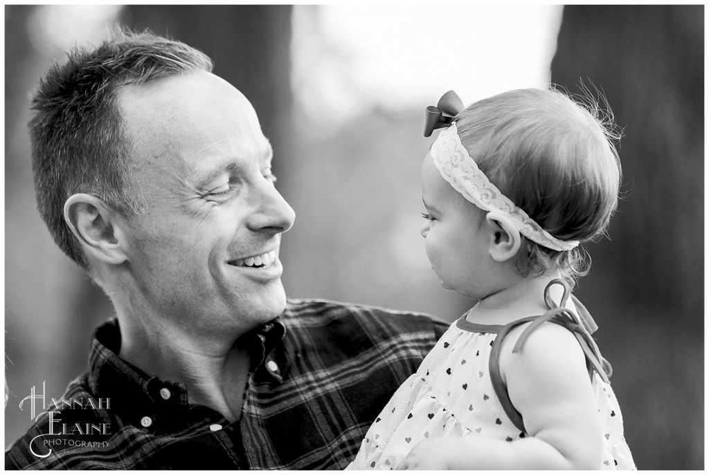 black and white image of a father holding his daughter