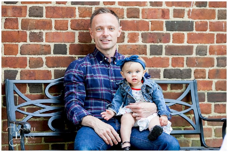 dad holds anna on a park bench