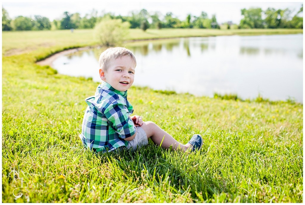 portrait of a little boy by the farm pond