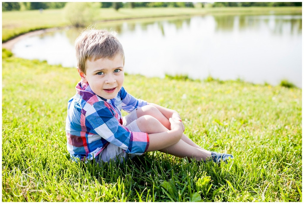 plaid shirt on a boy by the pond