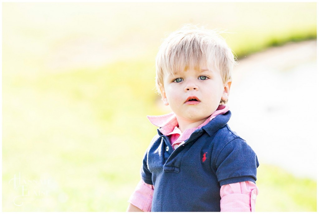 boy wears pink shirt under blue polo shirt