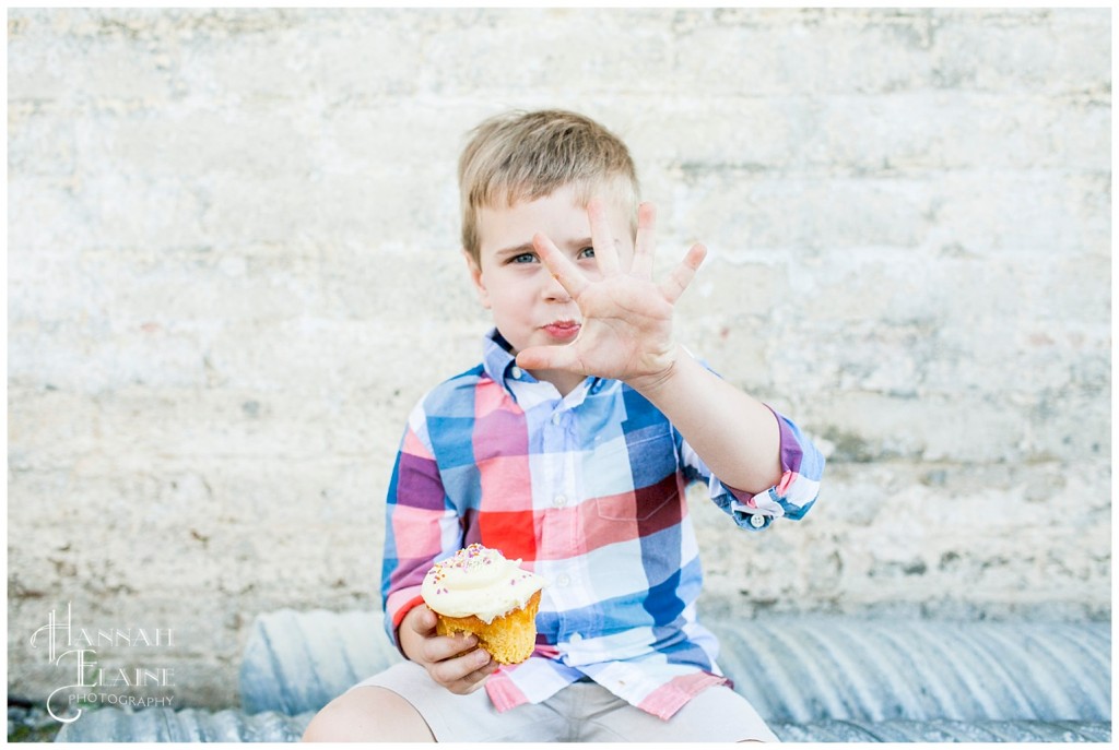 boy holds up five fingers to tell me his age