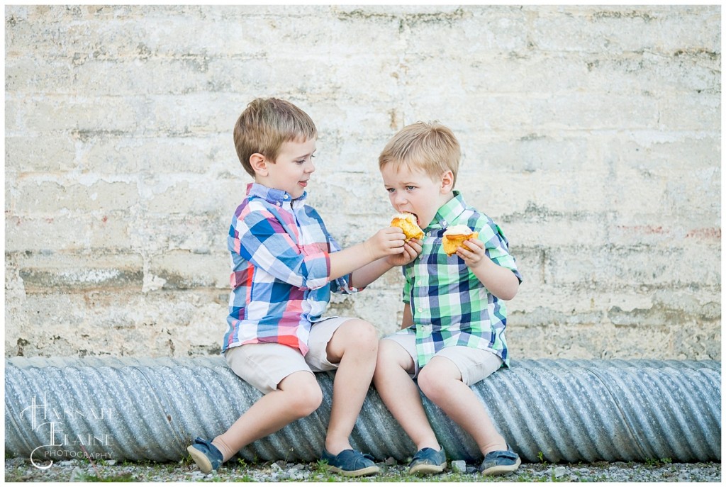 brothers take a bite of each other's cupcakes