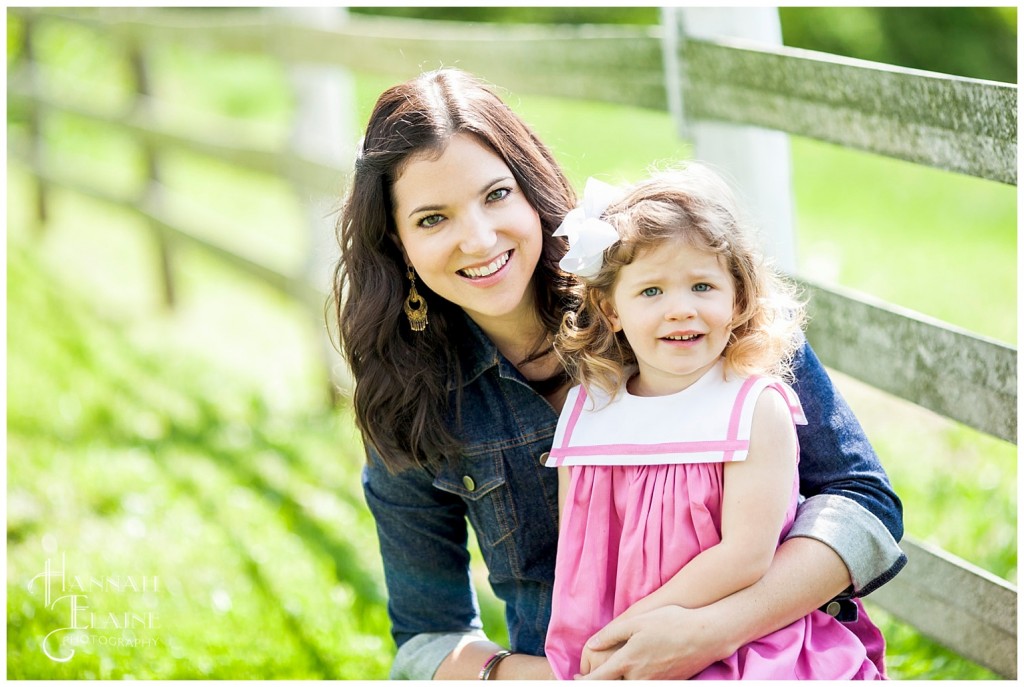 mom and daughter portrait along the white fence line