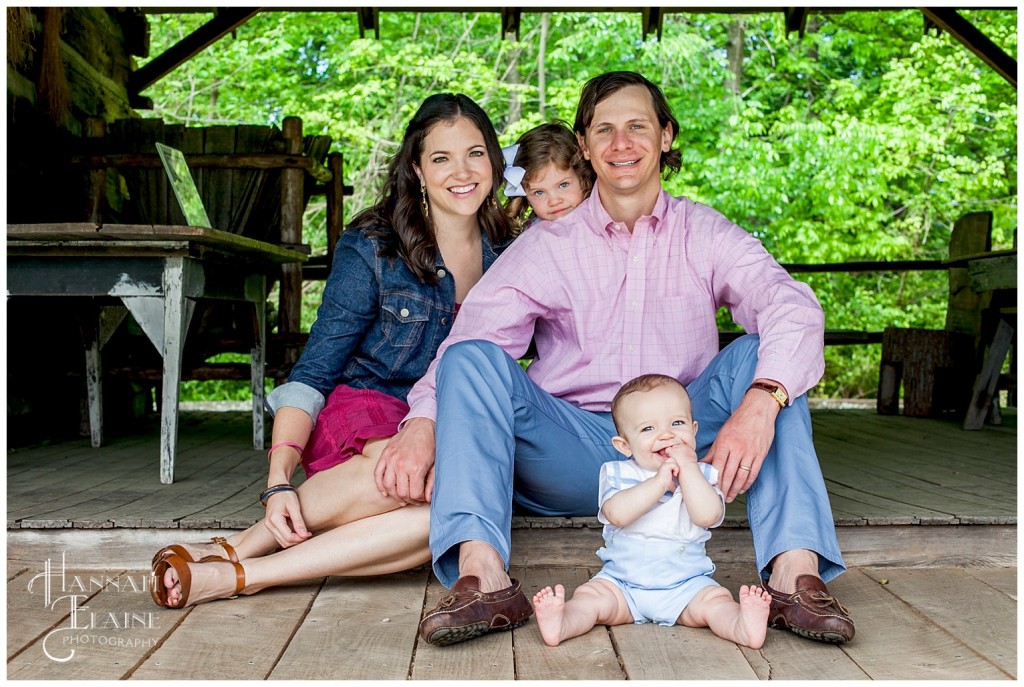 log cabin porch serves as the backdrop for family photos