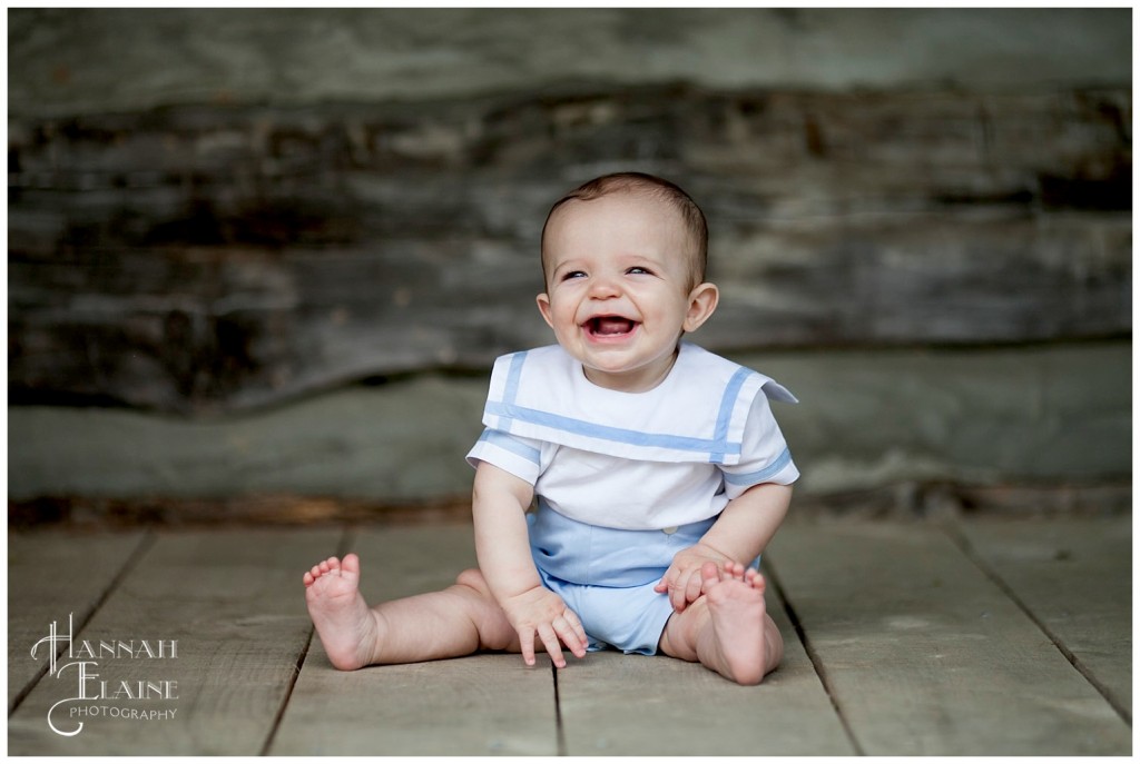 rustic log cabin setting for little boy's 7 month photos