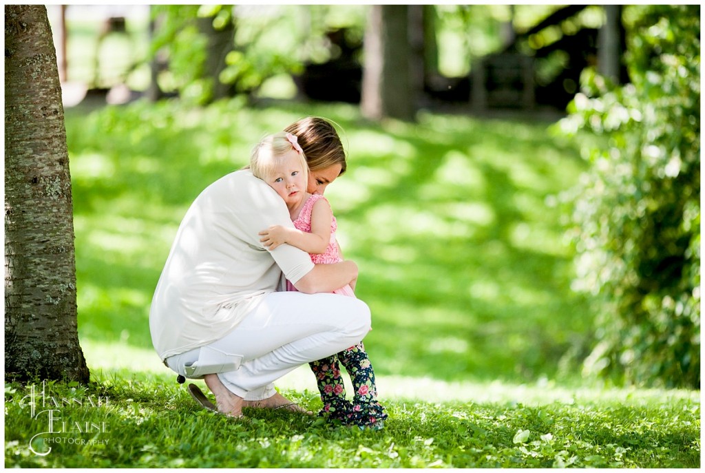 little girl gets a comforting hug from mommy