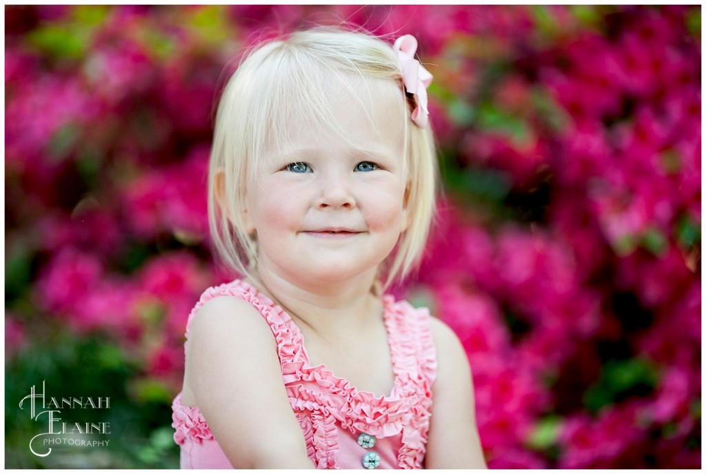 blond girl in front of hot pink azalea bush